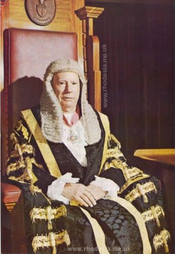 The Honourable J.W. Pithey, I.C.D., C.B.E., President of the Senate, seated in the President's chair.