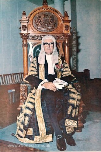 Colonel the Honourable G.H. Hartley, I.C.D., O.B.E., E.D., Speaker of the House of Assembly, seated in the Speaker's chair.