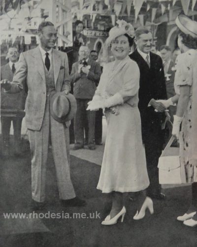 Their Majesties about to board the Royal Train. Princess Elizabeth is shaking hands with the Prime Minister, Sir Godfrey Huggins.
